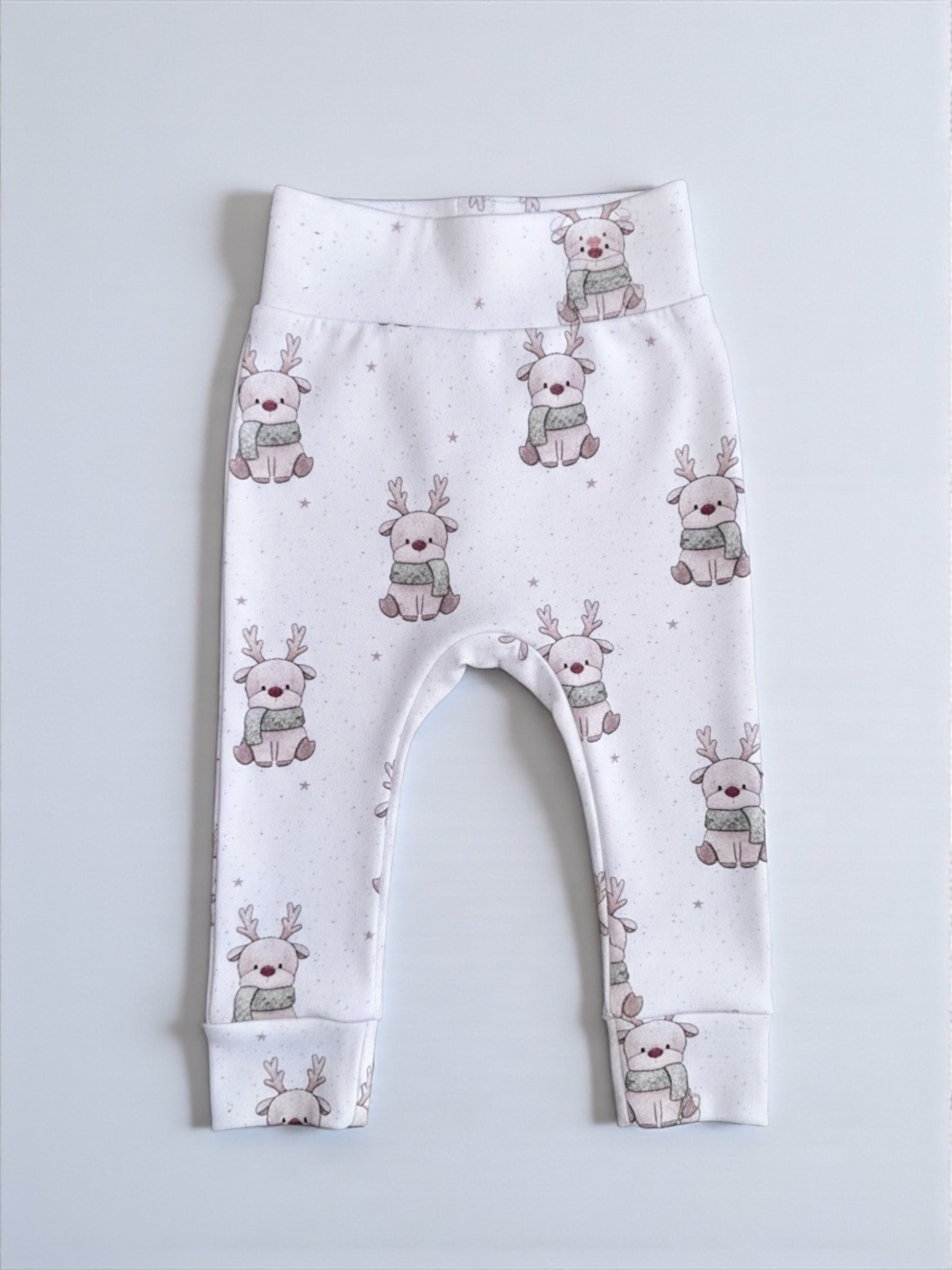 Baby leggings with reindeer pattern on a light gray background